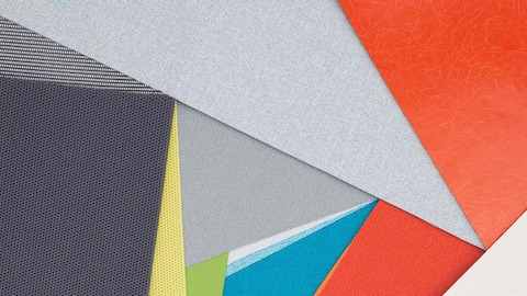 Layers of multi-colored fabric and material swatches showing the various textures, finishes and materials available. Layers of multi-colored fabric and material swatches showing the various textures, finishes and materials available.