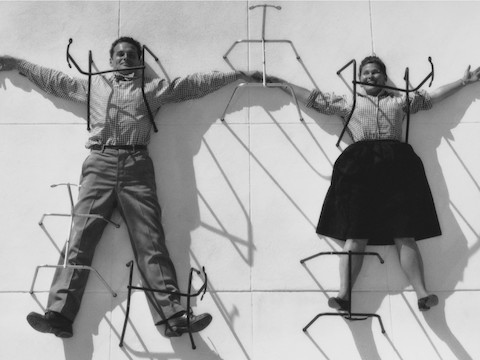 A vintage photo of Charles and Ray Eames holding hands in a playful posture. A vintage photo of Charles and Ray Eames holding hands in a playful posture.