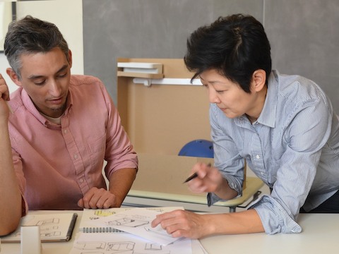 Product designers Cutter Hutton and Ayako Takase review a design drawing. Product designers Cutter Hutton and Ayako Takase review a design drawing.