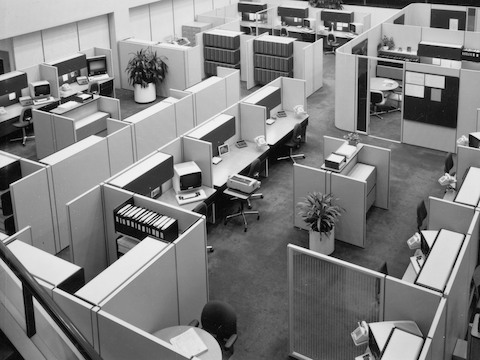 Archival photograph showing an overhead view of an office made of Action Office System with computer terminals, typewriters, and storage systems. Archival photograph showing an overhead view of an office made of Action Office System with computer terminals, typewriters, and storage systems.