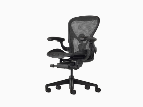 Black Aeron Chair on a white background with a 5-star base and ergonomic back support, viewed at an angle. Black Aeron Chair on a white background with a 5-star base and ergonomic back support, viewed at an angle.