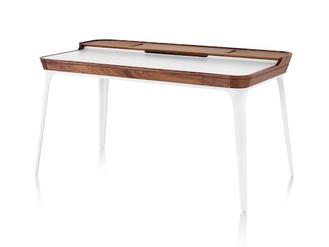 Three quarter profile view of white Airia Desk with dark wood trim and white legs. Three quarter profile view of white Airia Desk with dark wood trim and white legs.