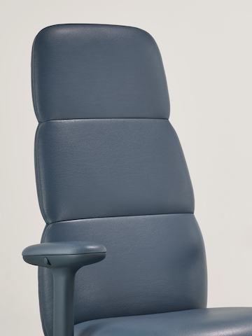 Detail view of a high-back Asari chair by Herman Miller in dark blue leather with height adjustable arms Detail view of a high-back Asari chair by Herman Miller in dark blue leather with height adjustable arms