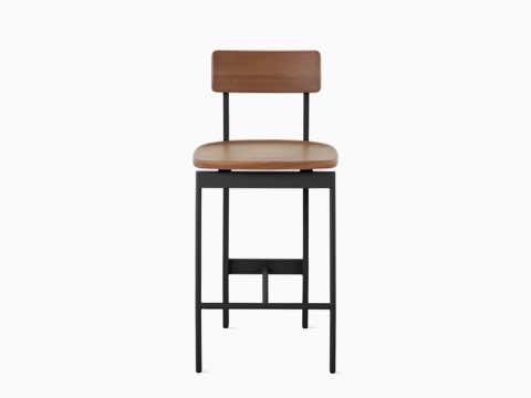 A walnut counter height Betwixt Stool with a black frame. A walnut counter height Betwixt Stool with a black frame.