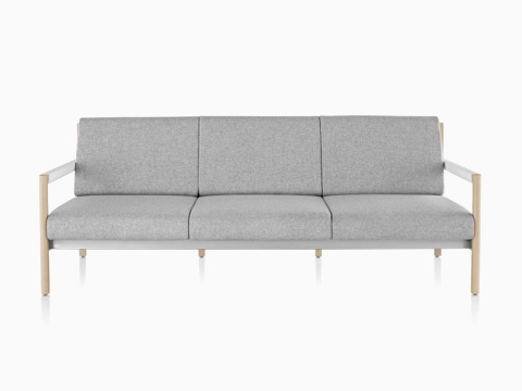 A light gray Brabo sofa with wood legs and white arms, viewed from the front. A light gray Brabo sofa with wood legs and white arms, viewed from the front.