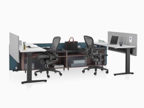 A Canvas Channel setting in dark green with lower storage, Motia height-adjustable tables, and black Aeron office chairs. A Canvas Channel setting in dark green with lower storage, Motia height-adjustable tables, and black Aeron office chairs.