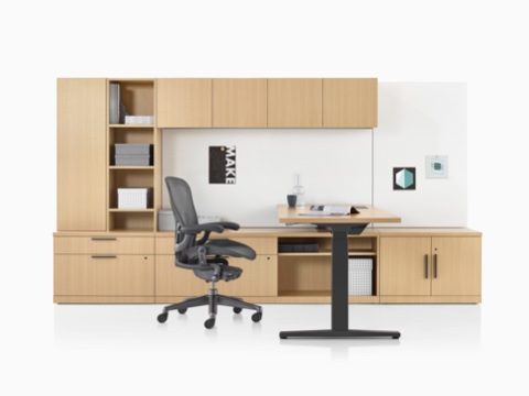 A Canvas Private Office with light wood storage, a height-adjustable desk, and a black Aeron office chair. A Canvas Private Office with light wood storage, a height-adjustable desk, and a black Aeron office chair.