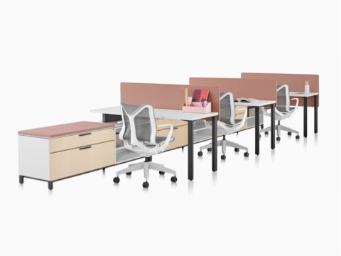 A Canvas Storage workstation with white surfaces, pink screens, and grey Cosm office chairs. A Canvas Storage workstation with white surfaces, pink screens, and grey Cosm office chairs.