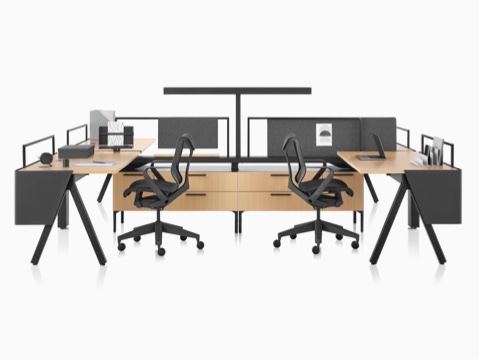 A Canvas Vista workstation in light wood and black with modesty screens, t-shaped lights, and black Cosm office chairs. A Canvas Vista workstation in light wood and black with modesty screens, t-shaped lights, and black Cosm office chairs.