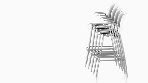 Profile view of white Caper Stacking Stools, stacked five-high. Profile view of white Caper Stacking Stools, stacked five-high.