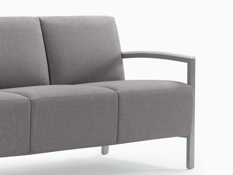 Front three-quarter view of Brava Modern Lounge Seating sofa with solid surface arm caps. our-values