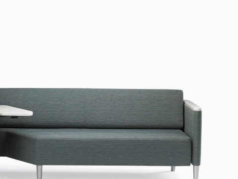 A Nemschoff Palisade Flop Sofa in dark gray textile with white solid surface arm caps and white adjustable table with Durawrap top. our-values