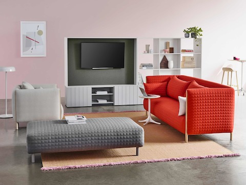 A casual work area with a red ColourForm sofa and a light gray ColourForm lounge chair and ottoman. A casual work area with a red ColourForm sofa and a light gray ColourForm lounge chair and ottoman.