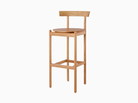 An oak bar-height Comma Stool, viewed from the front at an angle. An oak bar-height Comma Stool, viewed from the front at an angle.
