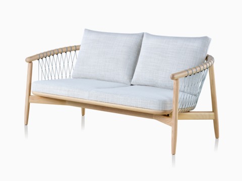 A light-colored Crosshatch Settee featuring gray upholstery and a white ash frame. A light-colored Crosshatch Settee featuring gray upholstery and a white ash frame.