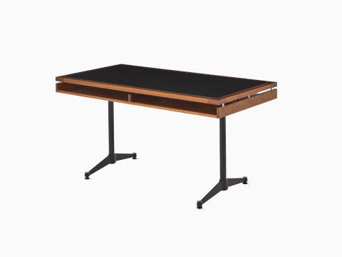 An Eames 2500 Series Executive Desk in walnut with black leather inlay. An Eames 2500 Series Executive Desk in walnut with black leather inlay.