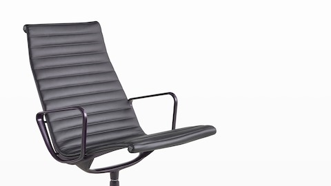 An Eames Aluminum Group Lounge Chair, viewed from the front at an angle. An Eames Aluminum Group Lounge Chair, viewed from the front at an angle.