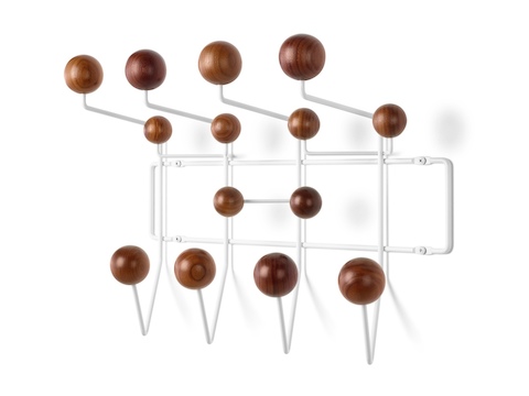 Angled view of an Eames Hang-It-All storage rack, featuring a white wire frame and wood knobs in a medium finish. Angled view of an Eames Hang-It-All storage rack, featuring a white wire frame and wood knobs in a medium finish.