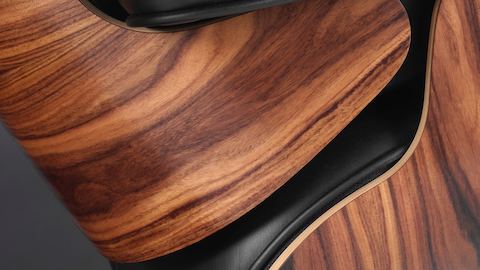 Close-up of the 7-ply veneer shell on an Eames Lounge Chair. Close-up of the 7-ply veneer shell on an Eames Lounge Chair.
