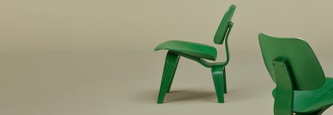 Green Eames Molded Plywood Chairs on sage background. Green Eames Molded Plywood Chairs on sage background.