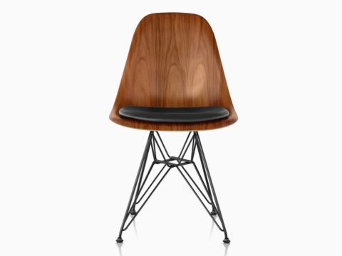 Eames Molded Wood side chair with a black seat pad and wire base, viewed from the front. Eames Molded Wood side chair with a black seat pad and wire base, viewed from the front.