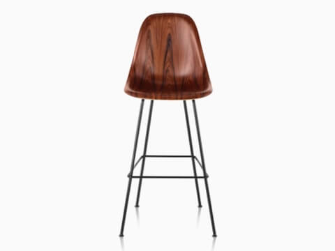 Upper half of an Eames Molded Wood Stool with a dark finish, viewed from the front. Upper half of an Eames Molded Wood Stool with a dark finish, viewed from the front.