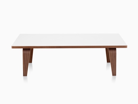 An Eames Rectangular Coffee Table with a white top and molded plywood legs in a medium finish. An Eames Rectangular Coffee Table with a white top and molded plywood legs in a medium finish.