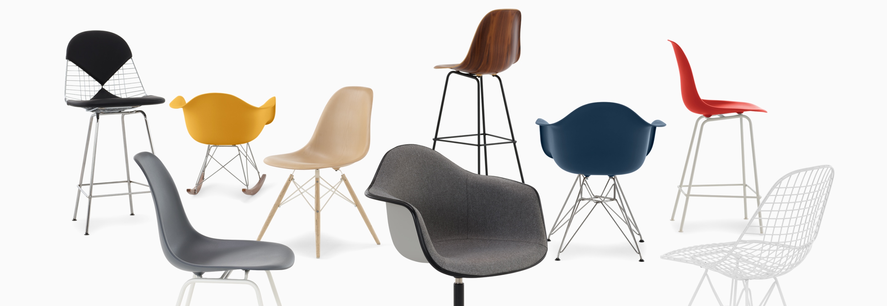 A casual arrangement of Eames shell chairs and stools in fiberglass, wire, wood, and plastic. A casual arrangement of Eames shell chairs and stools in fiberglass, wire, wood, and plastic.