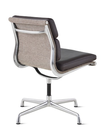 An Eames Soft Pad Management Chair with no arms, viewed from the back at an angle. An Eames Soft Pad Management Chair with no arms, viewed from the back at an angle.