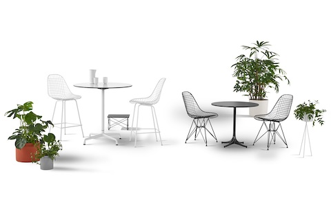 Two round Eames Tables of different heights, one served by two white Eames Wire Stools and one by two black Eames Wire Chairs. Two round Eames Tables of different heights, one served by two white Eames Wire Stools and one by two black Eames Wire Chairs.
