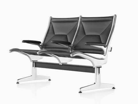 Angled view of black leather Eames Tandem Sling Seating with two seating positions. Angled view of black leather Eames Tandem Sling Seating with two seating positions.