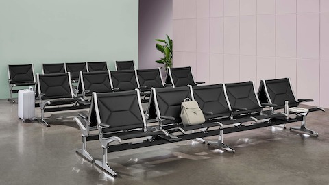 Multiple rows of Eames Tandem Sling Seating in a public waiting area. Multiple rows of Eames Tandem Sling Seating in a public waiting area.
