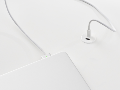 Ello Micro surface-integrated dual port USB-C power solution charging a laptop shown in white. Ello Micro surface-integrated dual port USB-C power solution charging a laptop shown in white.