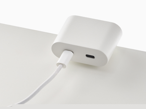 Ello Mini surface clamp USB-C power solution shown in white charging a laptop. Ello Mini surface clamp USB-C power solution shown in white charging a laptop.