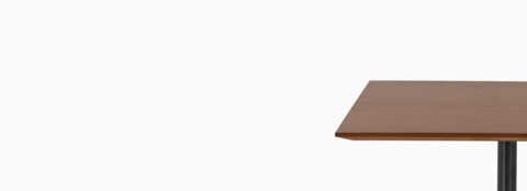Front profile of an Everywhere occasional table with square, thin edge, light brown walnut veneer top and single column occasional, black base. Front profile of an Everywhere occasional table with square, thin edge, light brown walnut veneer top and single column occasional, black base.