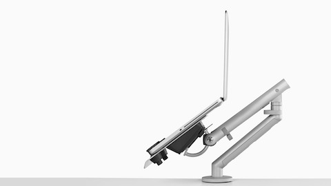 Profile view of an adjustable Flo Monitor Arm supporting an open laptop and positioned at a low angle. Profile view of an adjustable Flo Monitor Arm supporting an open laptop and positioned at a low angle.
