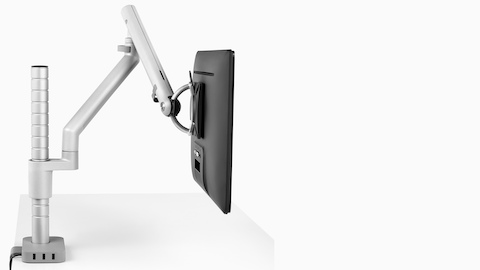 Profile view of a monitor supported by a Flo Modular monitor arm that's connected to a Flo Power Hub with three USB ports. Profile view of a monitor supported by a Flo Modular monitor arm that's connected to a Flo Power Hub with three USB ports.
