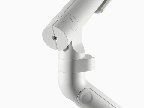 A close-up of a Flo Single monitor arm with directional indicator in white. A close-up of a Flo Single monitor arm with directional indicator in white.