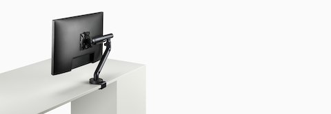 Flo Single monitor arm in black viewed at an angle. Flo Single monitor arm in black viewed at an angle.