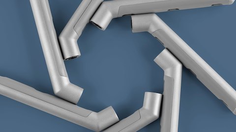 Partial view of seven Flo Monitor Arms arranged in a circle. Partial view of seven Flo Monitor Arms arranged in a circle.