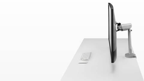 Silver Flo X Single monitor arm with a 43'' screen, viewed from the side. Silver Flo X Single monitor arm with a 43'' screen, viewed from the side.