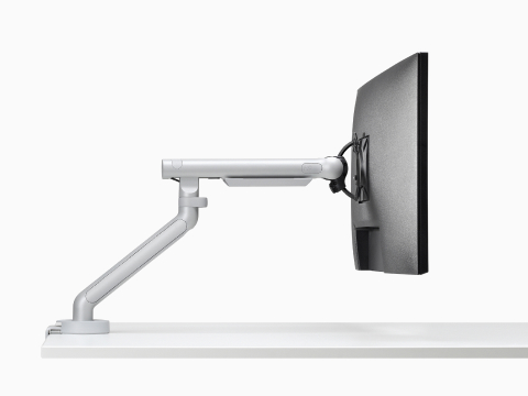 Flo Single monitor arm in silver viewed from the side. Flo Single monitor arm in silver viewed from the side.