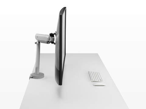 Silver single Flo X monitor arm with a 43'' screen, viewed from the side. Silver single Flo X monitor arm with a 43'' screen, viewed from the side.