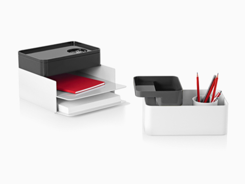 Two configurations of Formwork stackable desktop storage items, including paper trays, large and small boxes, and a pencil cup. Two configurations of Formwork stackable desktop storage items, including paper trays, large and small boxes, and a pencil cup.