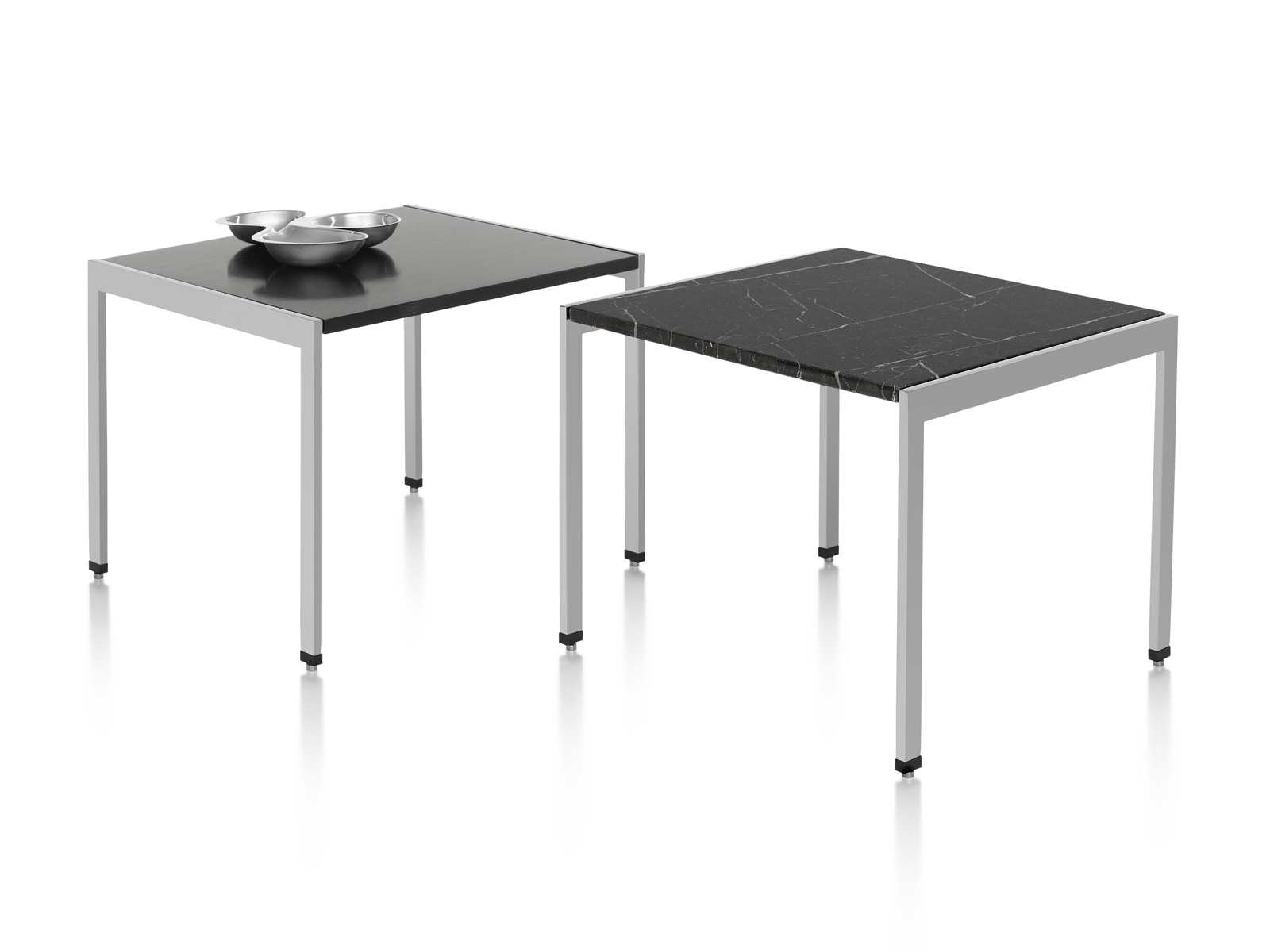 Two H Frame side tables, one with a black wood top and one with a black stone top. Two H Frame side tables, one with a black wood top and one with a black stone top.