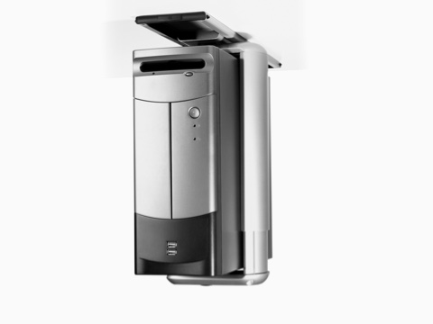 A silver CPU secured with an aluminum clamp and attached to the underside of a work surface. A silver CPU secured with an aluminum clamp and attached to the underside of a work surface.