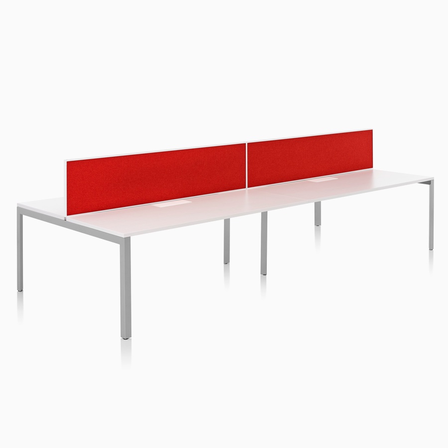 A Layout Studio bench for four with a white laminate top, gray legs, and red framed fabric center privacy screens. A Layout Studio bench for four with a white laminate top, gray legs, and red framed fabric center privacy screens.