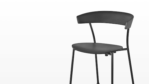 A black Leeway Chair with black metal base, viewed from an angle. A black Leeway Chair with black metal base, viewed from an angle.
