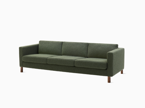 Three seater Lispenard Sofa, 17 inches in dark green textile and 6 inches walnut legs. Three seater Lispenard Sofa, 17 inches in dark green textile and 6 inches walnut legs.