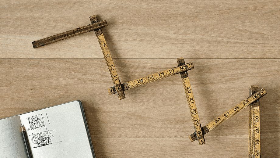 An animated gif showing an overhead view of an antique folding ruler articulating back and forth on one of its hinges, next to an open sketchbook with a pencil in it, all on a light wood surface. An animated gif showing an overhead view of an antique folding ruler articulating back and forth on one of its hinges, next to an open sketchbook with a pencil in it, all on a light wood surface.